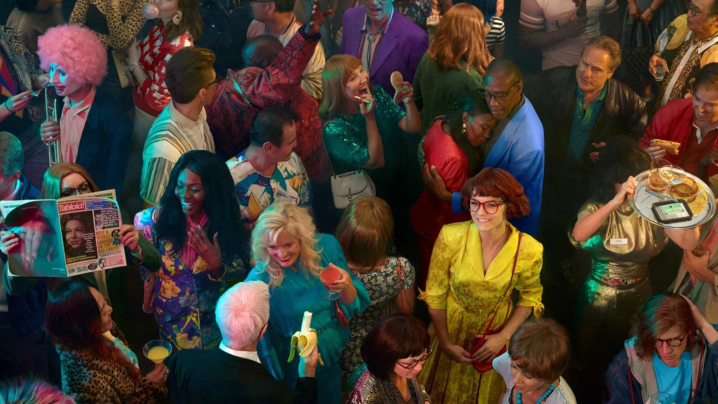  crowded room with people in colorful outfits